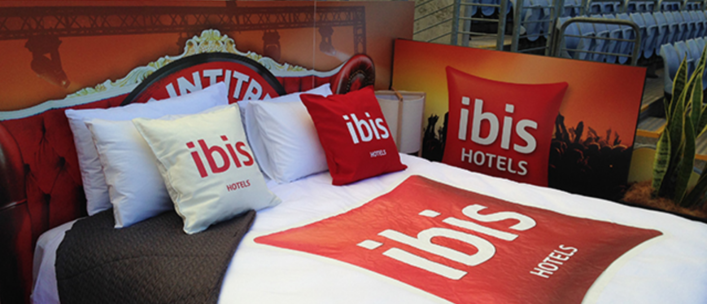 Bedsheets, pillows, and beds displayed with the 'ibis hotels' print